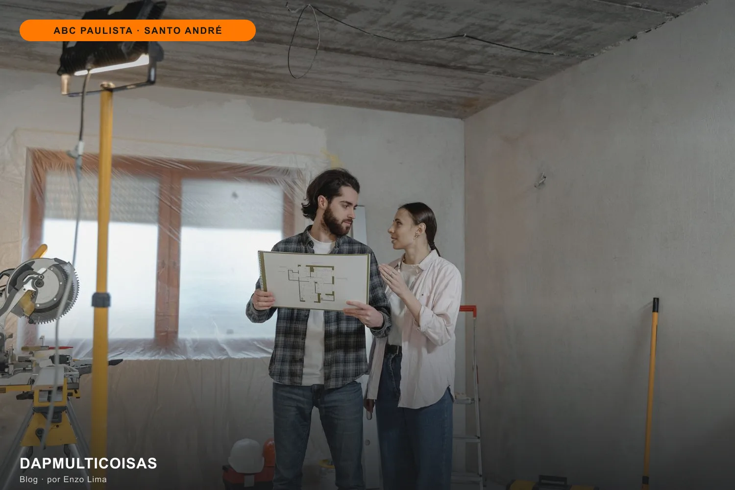 Casal em uma casa em reforma olhando o projeto em uma prancheta